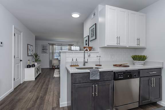 A kitchen with dark wood cabinets and stainless steel appliances. at Ten31, Dayton, Ohio