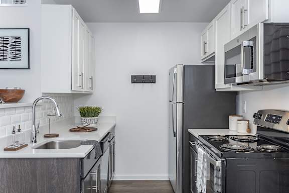 A modern kitchen with a black refrigerator and stove. at Ten31, Ohio