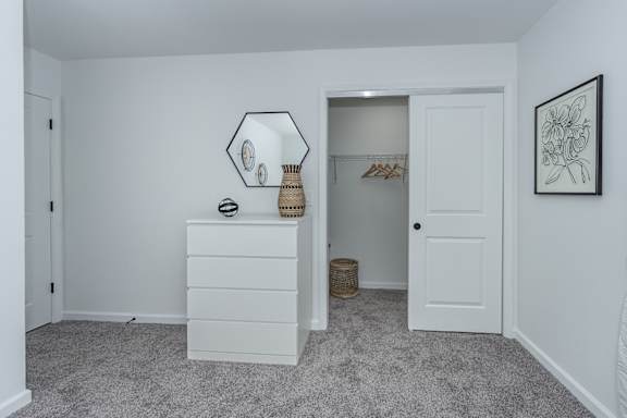 A white room with a dresser and a mirror. at Ten31, Dayton, Ohio