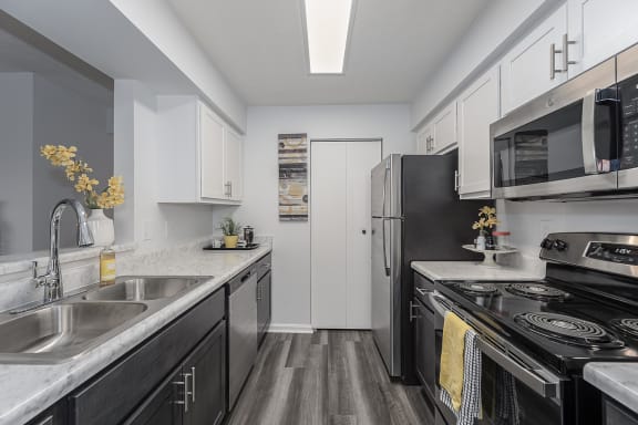 Ktchen with white cabinetry and black appliances at Indian Lookout, West Carrollton, 45449