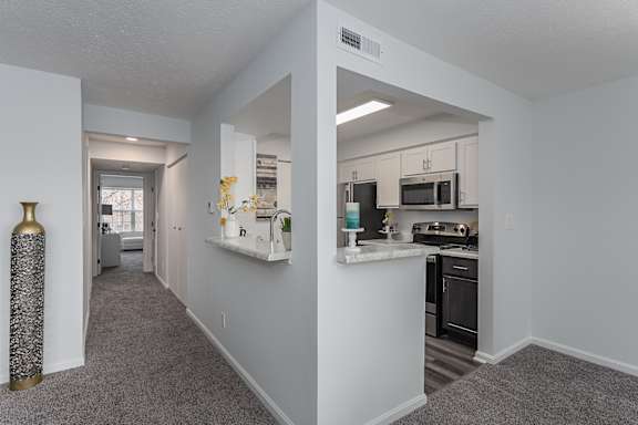 A kitchen with white cabinets and a black oven at Indian Lookout Apartments, Ohio