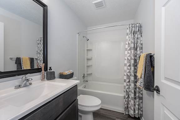 A white sink with a silver faucet and a mirror above it at Indian Lookout Apartments, West Carrollton, 45449