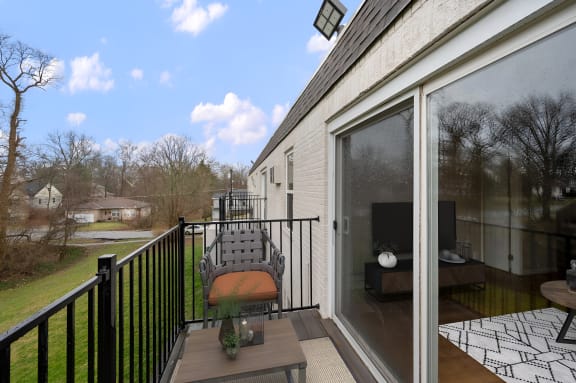 a balcony with a chair and a table with a vase on it at Cincinnati Premier Living*, Cincinnati, OH, 45213