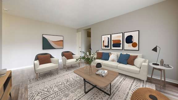 A living room with a white couch, two chairs, and a coffee table.
