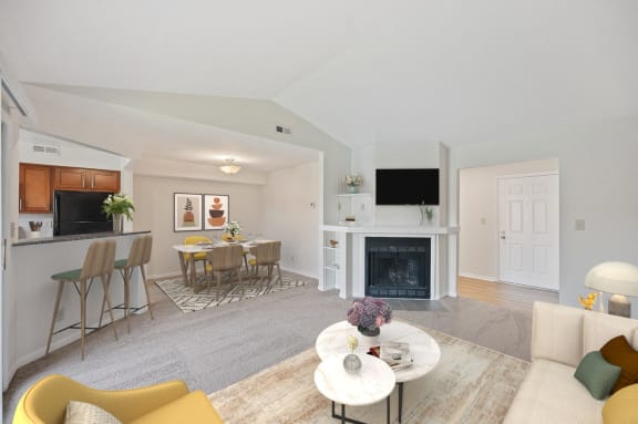 a living room with a fireplace and a table with chairs