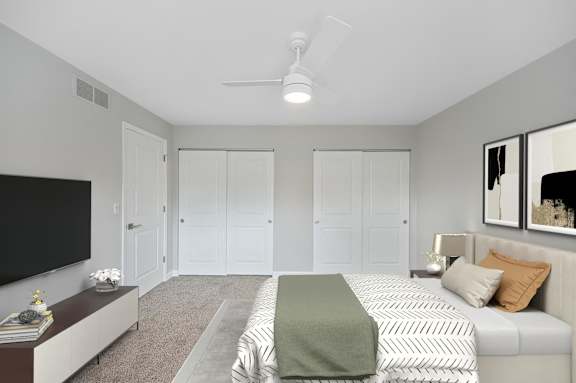 a bedroom with a large bed and a ceiling fan at Indian Creek Apartments*, Cincinnati, Ohio