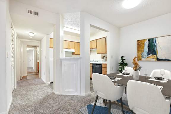 A dining room with a table set for four.