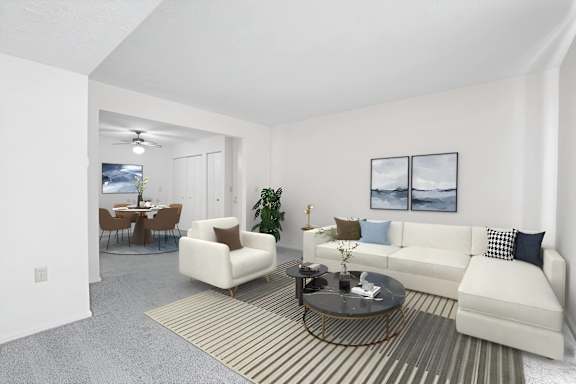 A living room with a white couch, a coffee table, and a dining table with chairs.
