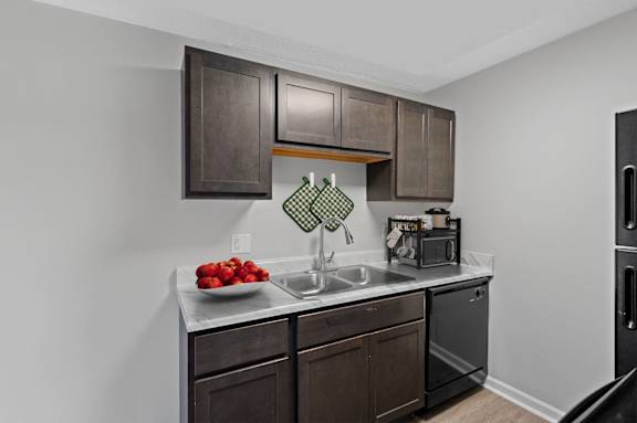 A kitchen with brown cabinets and a white countertop.