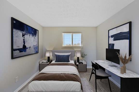 A bedroom with a bed, desk, and two framed pictures on the wall.