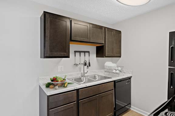 A kitchen with brown cabinets and a white countertop.