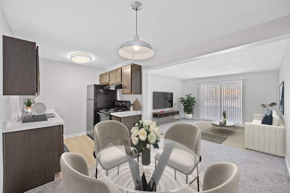A modern living room with a kitchen area in the background.