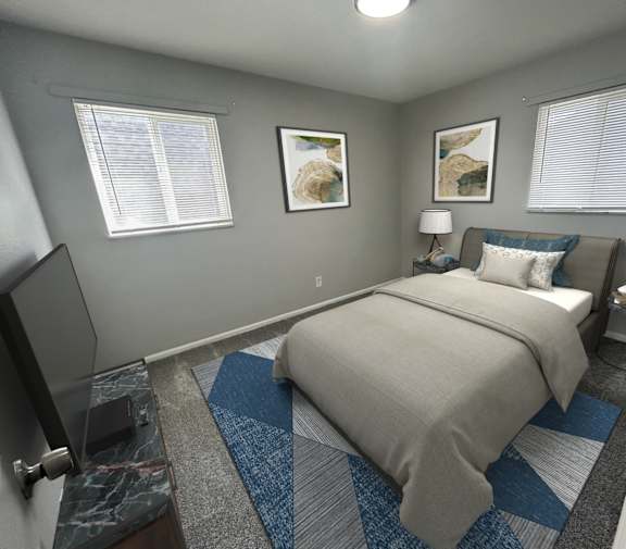 A bedroom with a bed, a television, and two pictures on the wall.