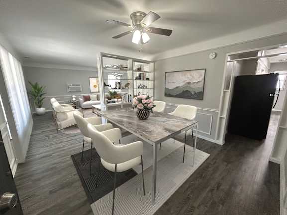 A dining room with a table and chairs.
