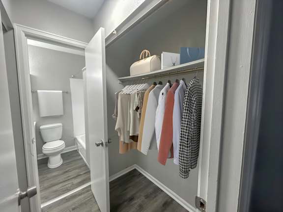 A white toilet is in a small bathroom.