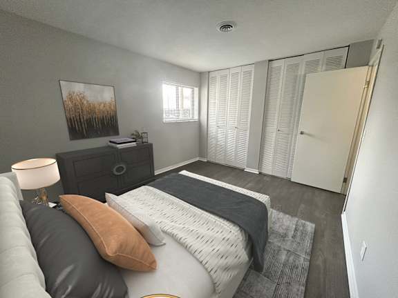 A bedroom with a bed, dresser, and a painting on the wall.