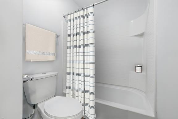 A white toilet and sink in a bathroom.