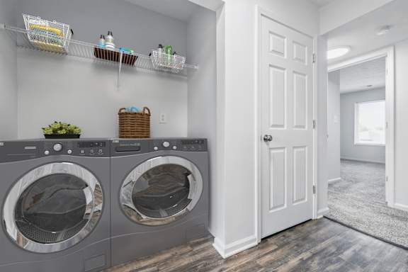 A laundry room with two front-loading washing machines.