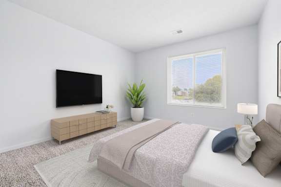 A bedroom with a bed, a television, and a potted plant.