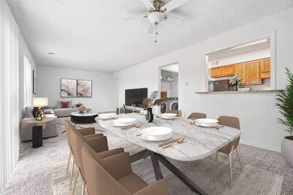 A dining room with a table set for six people.