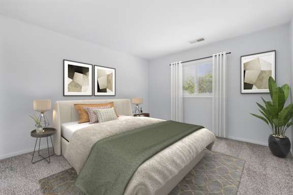 A bedroom with a bed, a nightstand, a lamp, a potted plant, and two framed pictures on the wall.