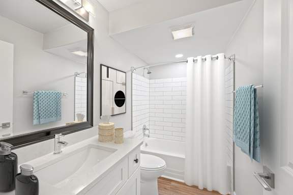 A white bathroom with a white tub and toilet. A white bathroom with a white tub and toilet. at Indian Creek Apartments*, Cincinnati, Ohio