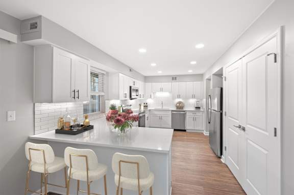A modern kitchen with white cabinets and a central island. A modern kitchen with white cabinets and a central island. at Indian Creek Apartments*, Cincinnati, OH, 45236