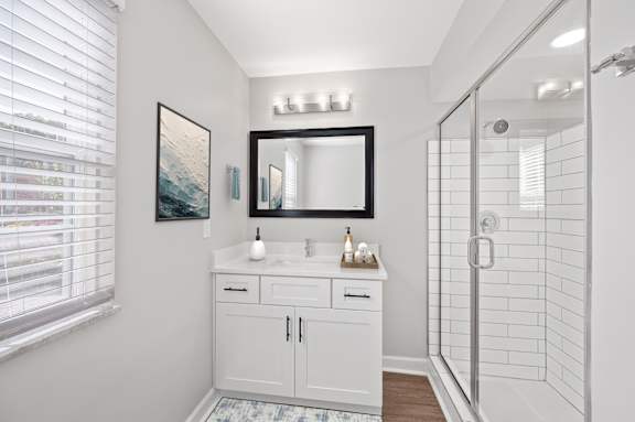 A bathroom with a white cabinet and a large mirror above it. A bathroom with a white cabinet and a large mirror above it. at Indian Creek Apartments*, Ohio