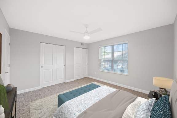 A bedroom with a bed, a ceiling fan, and a window with blinds. A bedroom with a bed, a ceiling fan, and a window with blinds. at Indian Creek Apartments*, Cincinnati, OH, 45236