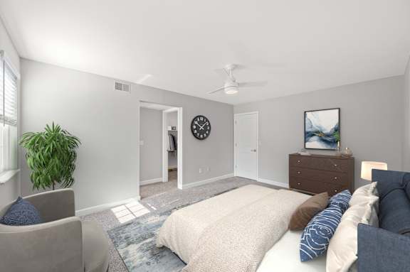 A bedroom with a bed, chair, and a plant. A bedroom with a bed, chair, and a plant. at Indian Creek Apartments*, Cincinnati, Ohio