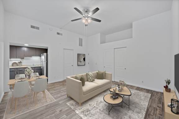 A living room with a couch, chairs, and a coffee table.
