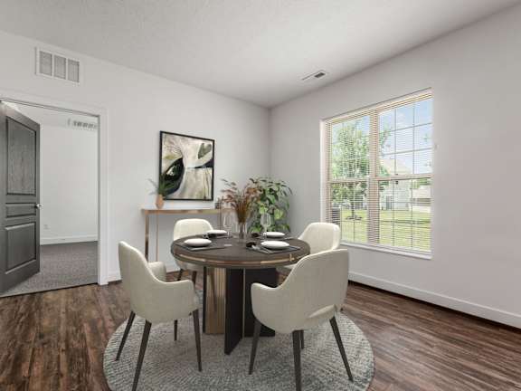 A dining room with a round table and chairs. at River View at Bexley Apartments, Ohio, 43209