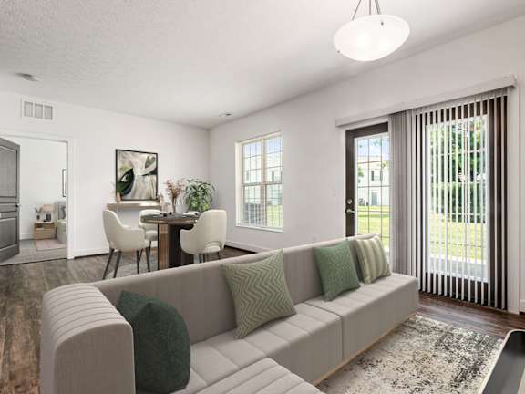 A living room with a grey couch and a rug. at River View at Bexley Apartments, River View at Bexley, OH