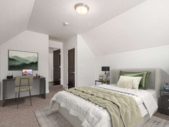 A bedroom with a large bed and a desk with a chair. at River View at Bexley Apartments, Ohio
