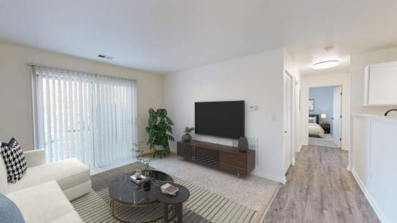 A living room with a white couch and a black television.