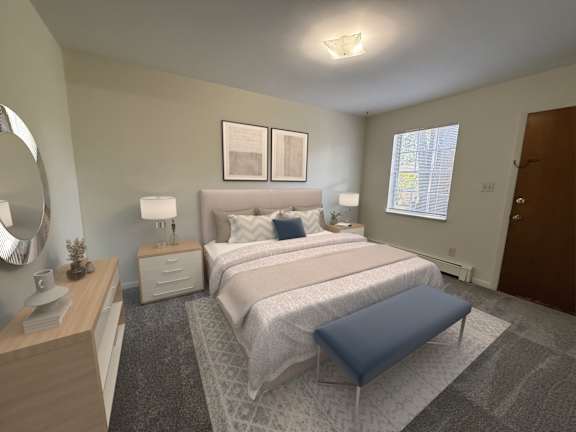 A bedroom with a large bed and a blue ottoman.