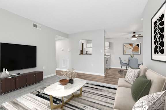 A living room with a white couch and a coffee table.