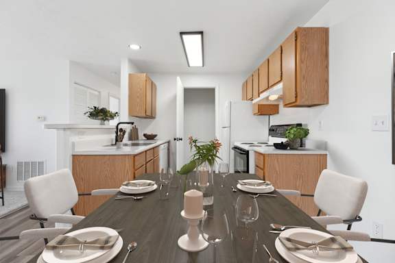 A modern dining room with a long table set for a meal.
