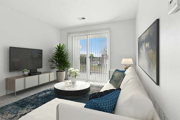 A living room with a white couch, a television, a plant, and a painting on the wall.
