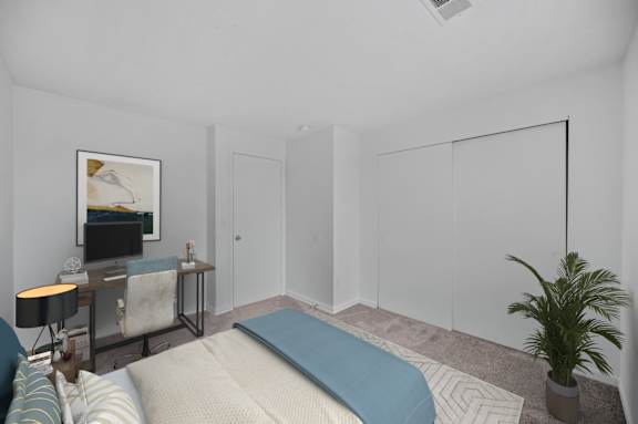 A bedroom with a bed, a painting, a lamp, a plant, and a table.