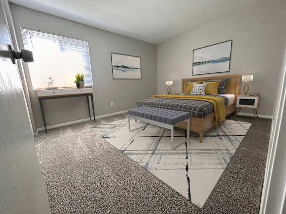 A bedroom with a bed, nightstand, and window.
