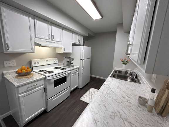 A kitchen with white appliances and cabinets.