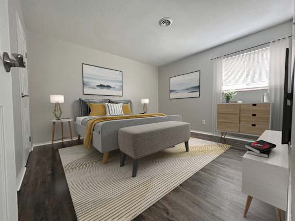 A bedroom with a bed, nightstand, and chair.
