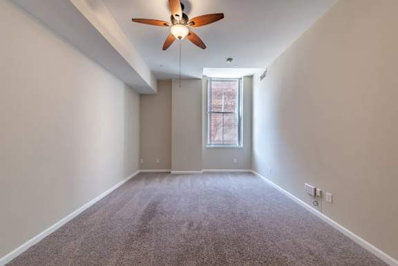 Empty bedroom with vaulted ceiling and window at Renaissance at the Power Building Apartments, Ohio