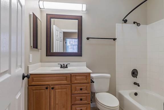 Bathroom with wood vanity and shower tub combo at Renaissance at the Power Building Apartments, Cincinnati, OH 45202