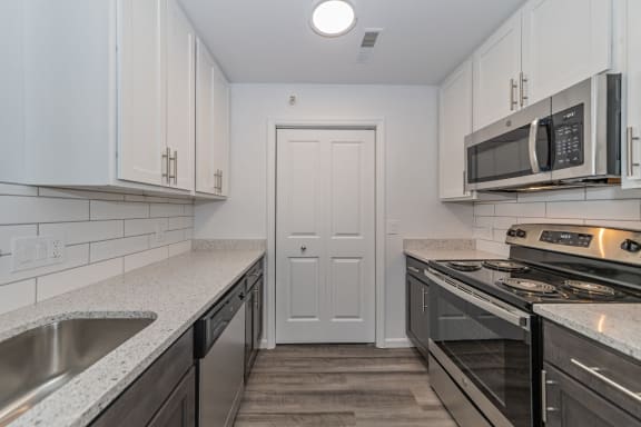 a kitchen with granite counter tops and stainless steel appliances at Ivy Hills Living Spaces, Cincinnati, 45244