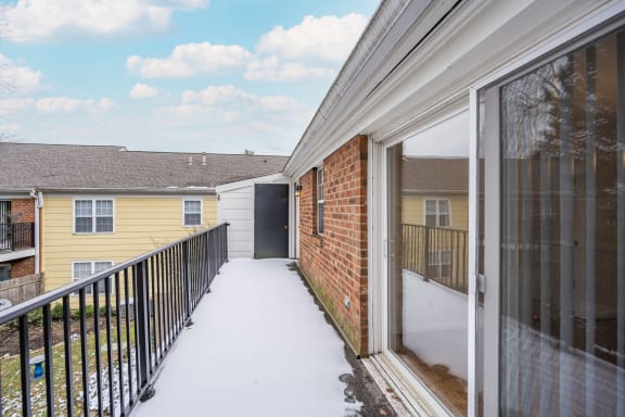 Balcony with a brick building and a yellow house at Indian Creek Apartments*, Ohio