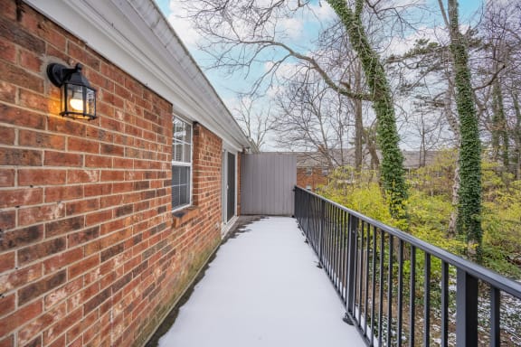 Deck of a brick house with a black railing and a brick wall at Indian Creek Apartments*, Ohio, 45236