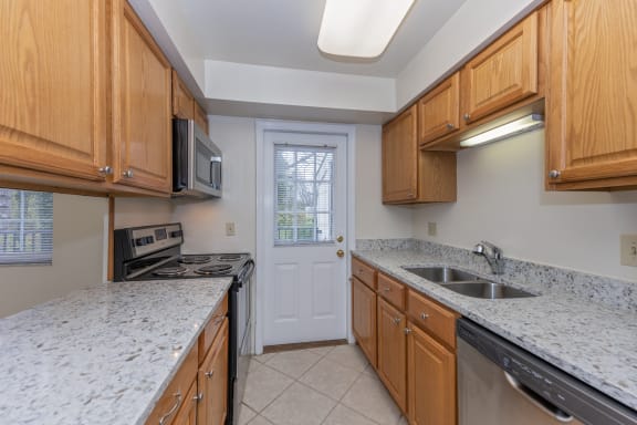 Kitchen with granite counter tops and wooden cabinets at Indian Creek Apartments*, Ohio, 45236