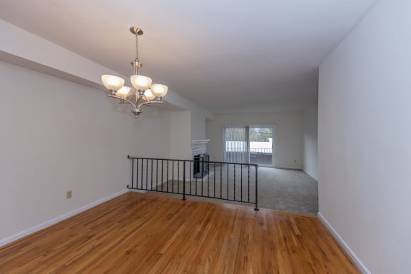 a living room and dining room with a chandelier and a window at Indian Creek Apartments*, Cincinnati, Ohio